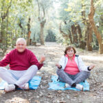 senior couple doing yoga together park