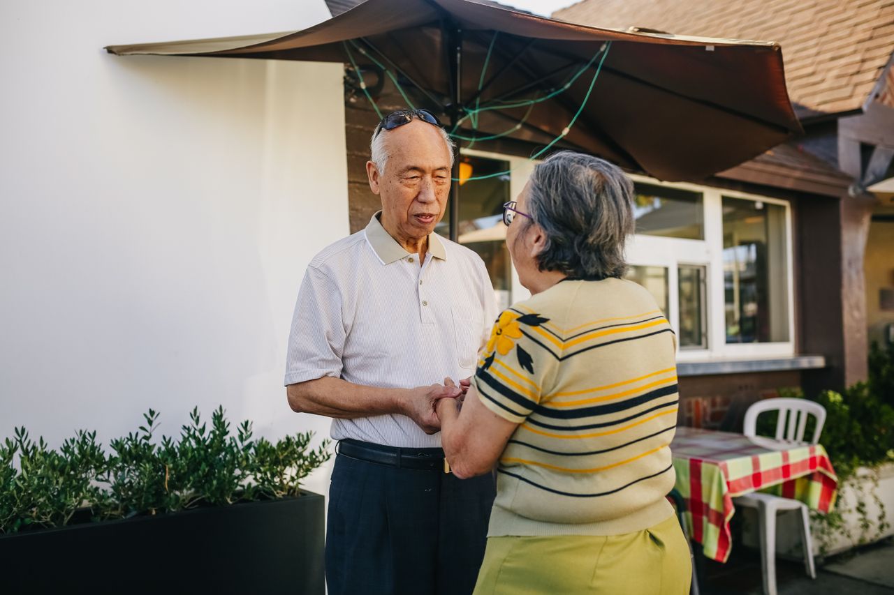 Crafting Captivating Headlines: Your awesome post title goes here Senior Asian couple holding hands and expressing love and affection in a sunny outdoor setting.